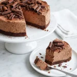 Delia Smith chocolate ricotta cheesecake with chocolate curls cocoa powder and a slice