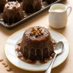 Delia Smith sticky toffee pudding served with pecan toffee sauce and cream